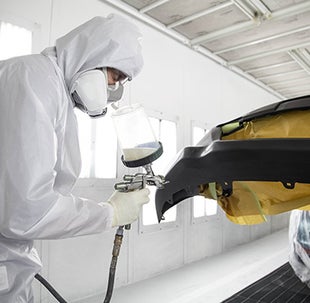 Collision Center Technician Painting a Vehicle | Bob Johnson Toyota in Rochester NY