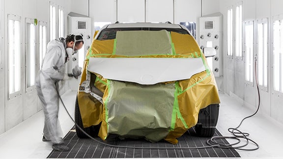Collision Center Technician Painting a Vehicle | Bob Johnson Toyota in Rochester NY